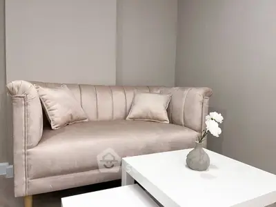 Elegant living room with plush sofa and modern white coffee table, perfect for cozy relaxation.