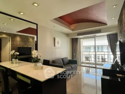 Modern living room with stylish ceiling and balcony view, featuring sleek furniture and natural light.