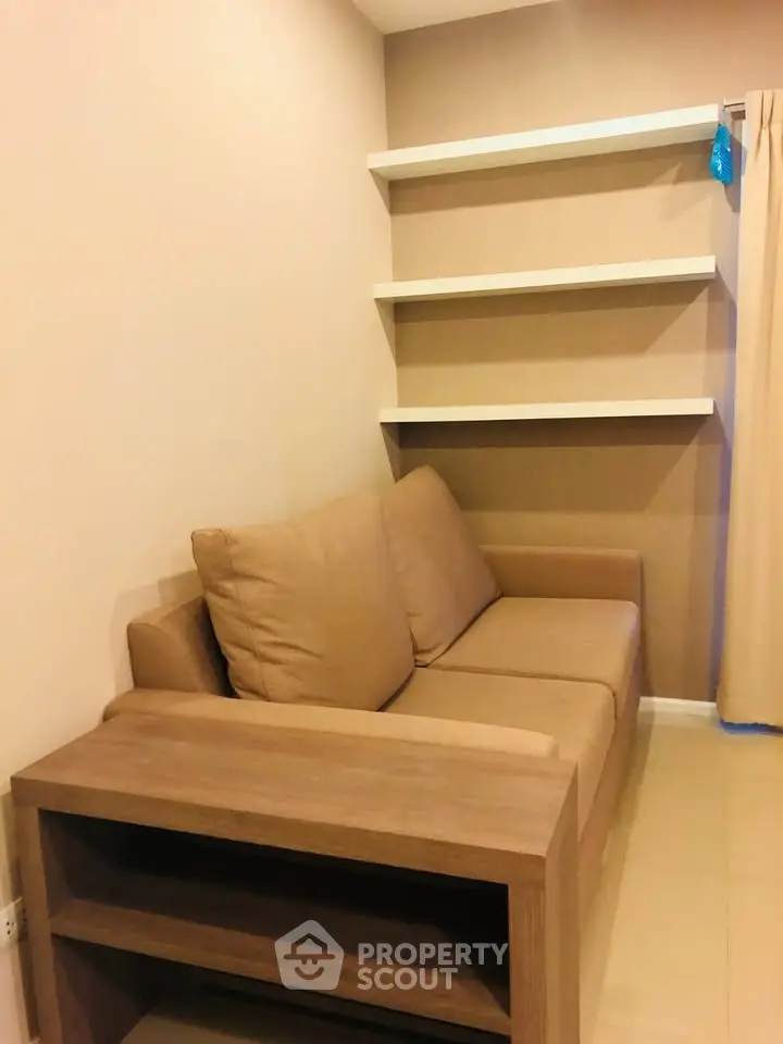 Cozy living room with beige sofa and modern shelving, perfect for relaxation and stylish storage.