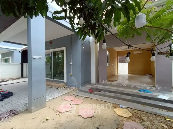 Spacious modern home exterior with covered patio and garden area
