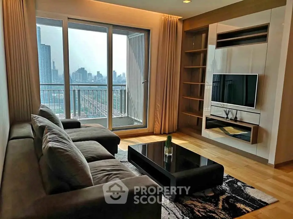 Modern living room with city view, featuring sleek furniture and floor-to-ceiling windows.