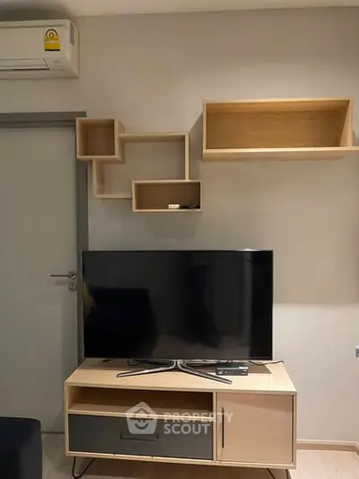 Modern living room with sleek TV setup and stylish shelving