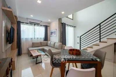 Modern living room with sleek design, featuring a cozy sectional sofa and stylish dining area.