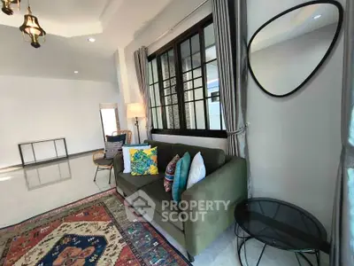 Spacious living room with stylish decor and large windows for natural light.