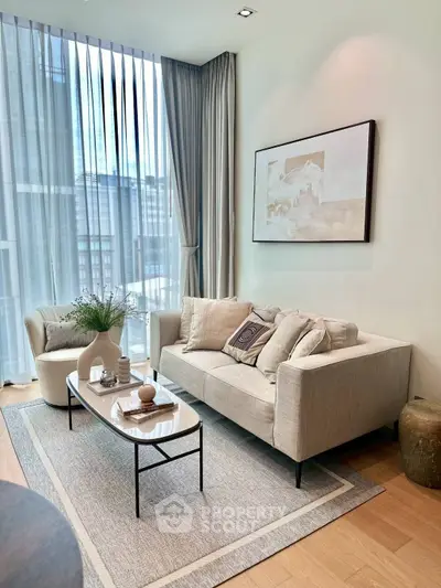 Elegant living room with modern decor and large window for natural light