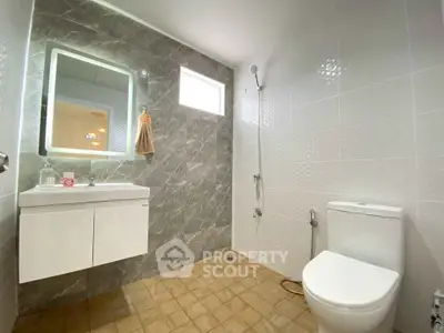 Modern bathroom with sleek design and illuminated mirror