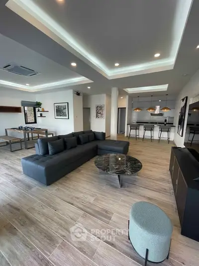 Spacious modern living room with open kitchen and stylish decor