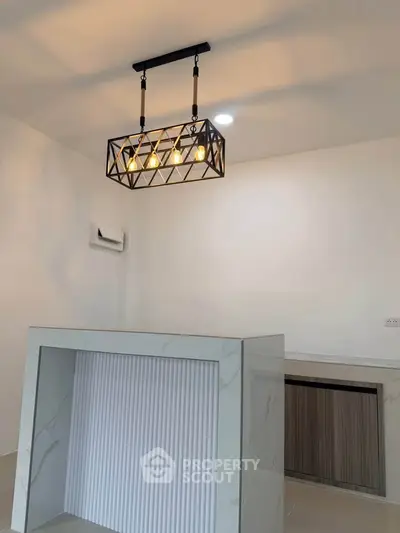 Modern kitchen with stylish pendant lighting and sleek marble countertop
