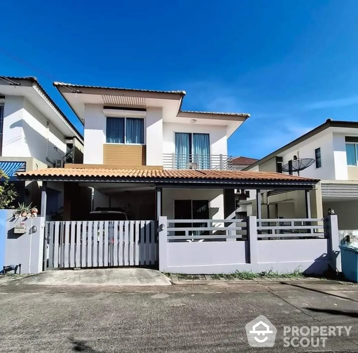 Charming two-story house with gated driveway and modern facade in a serene neighborhood.