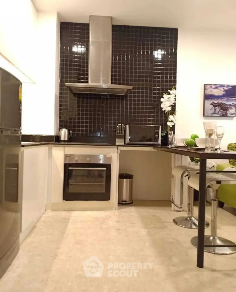 Modern kitchen with sleek black backsplash and stainless steel appliances