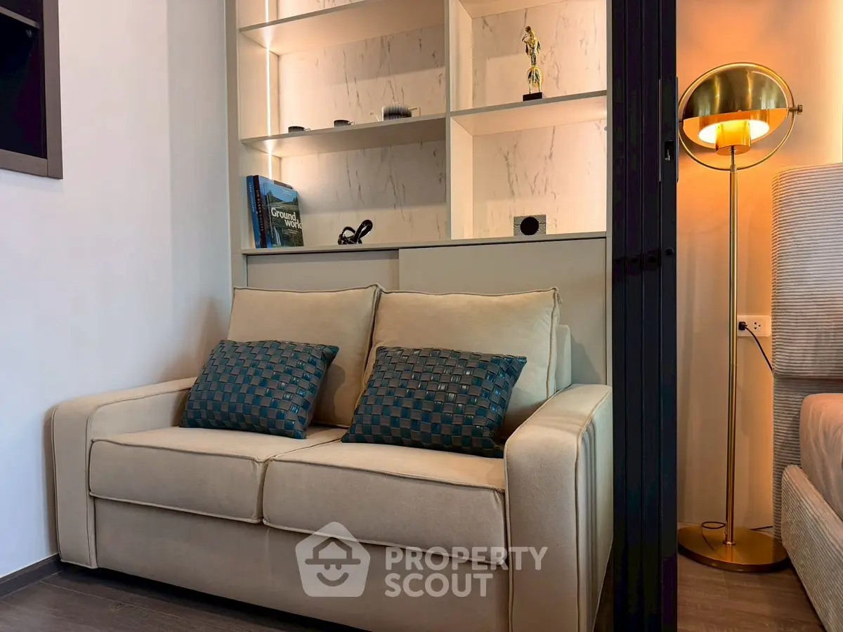 Cozy living room with elegant sofa and stylish lighting, perfect for relaxation and modern living.