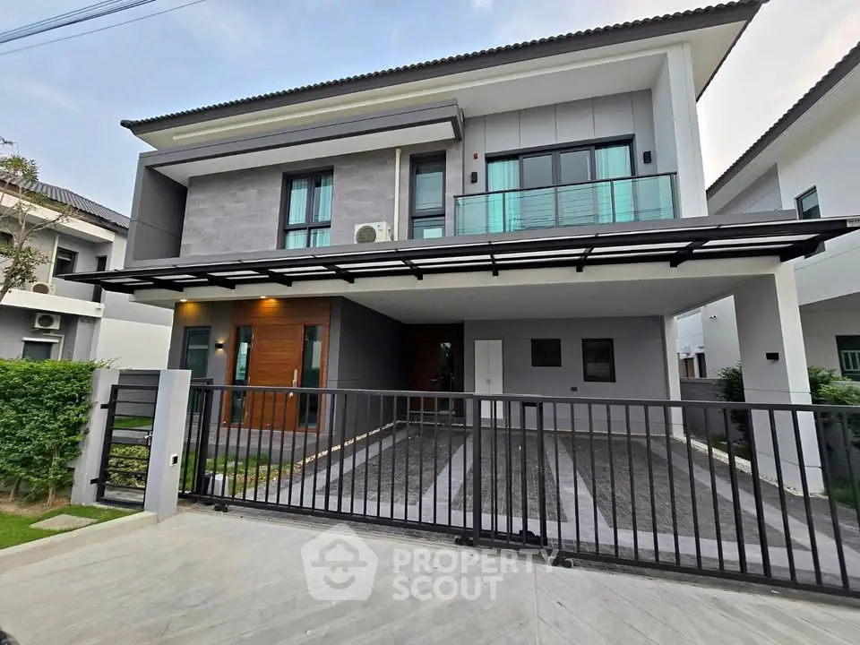 Modern two-story house with sleek design and spacious driveway in a serene neighborhood.