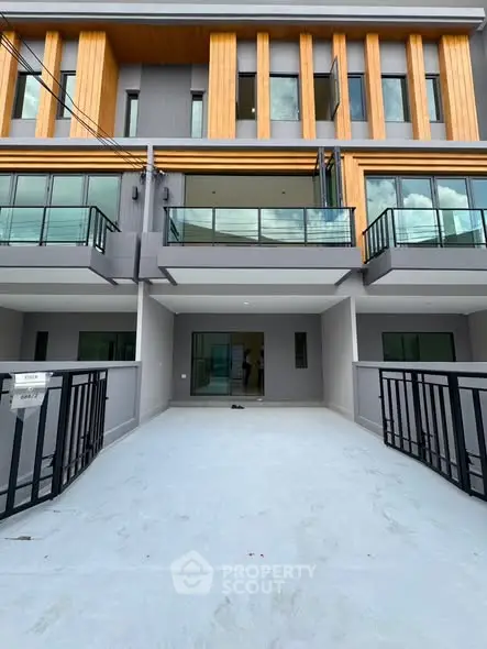 Modern multi-story townhouse with sleek design and spacious balcony.