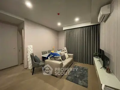 Modern living room with cozy sofa, dining area, and air conditioning.