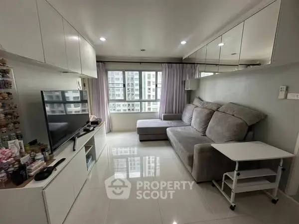 Modern living room with sleek design and large windows in urban apartment.