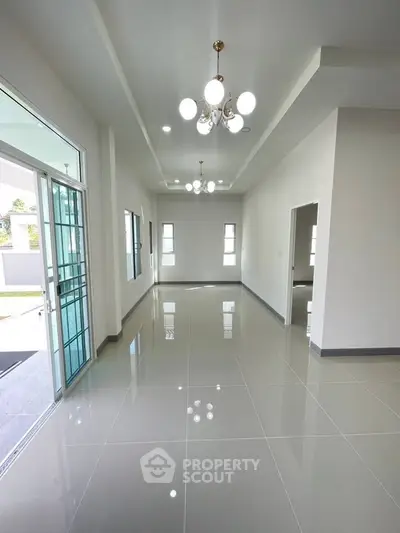 Spacious modern living room with elegant lighting and large windows for natural light.