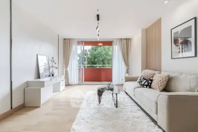 Spacious living room with modern decor and large balcony view