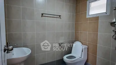 Modern bathroom with sleek fixtures and neutral tile design