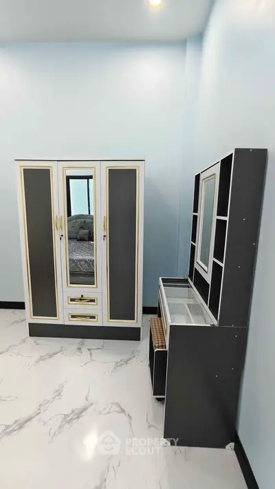 Modern bedroom with stylish wardrobe and dressing table on marble floor