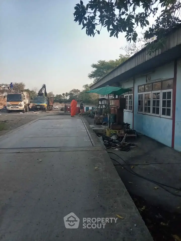 Industrial property with trucks and equipment, ideal for logistics or manufacturing.