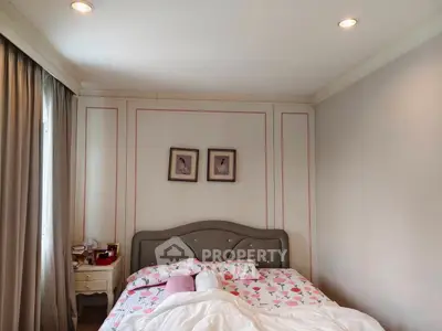 Cozy bedroom with elegant decor and soft lighting, featuring a stylish bed and charming wall art.