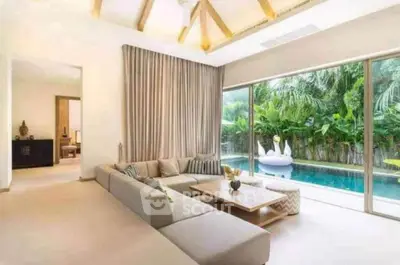 Luxurious living room with pool view and modern decor