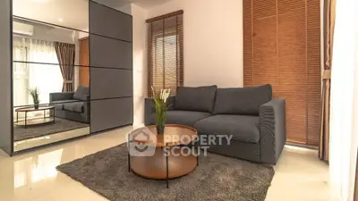 Modern living room with sleek grey sofa and stylish coffee table