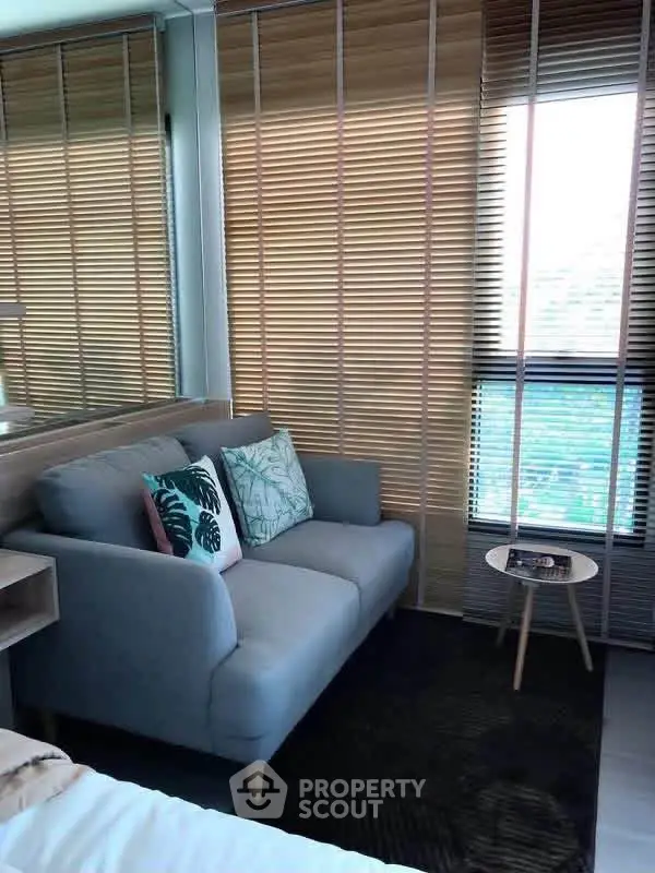 Cozy living room with stylish sofa and modern decor in a bright apartment.