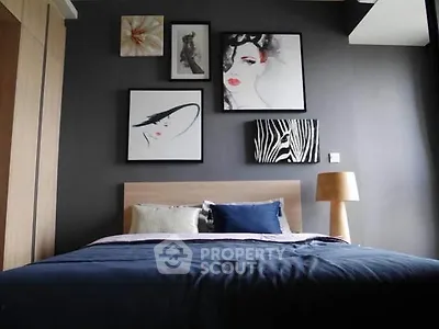 Stylish bedroom with modern art and cozy lighting in a contemporary apartment.