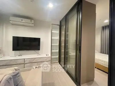 Modern living room with sliding glass doors and sleek TV setup