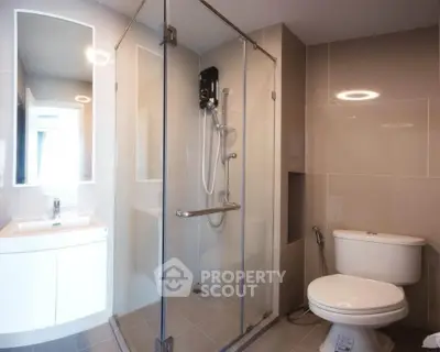Modern bathroom with glass shower enclosure and sleek fixtures