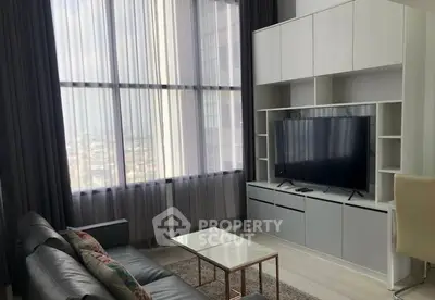Modern living room with large window and sleek entertainment center
