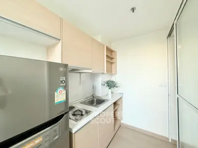 Modern compact kitchen with sleek cabinetry and stainless steel appliances