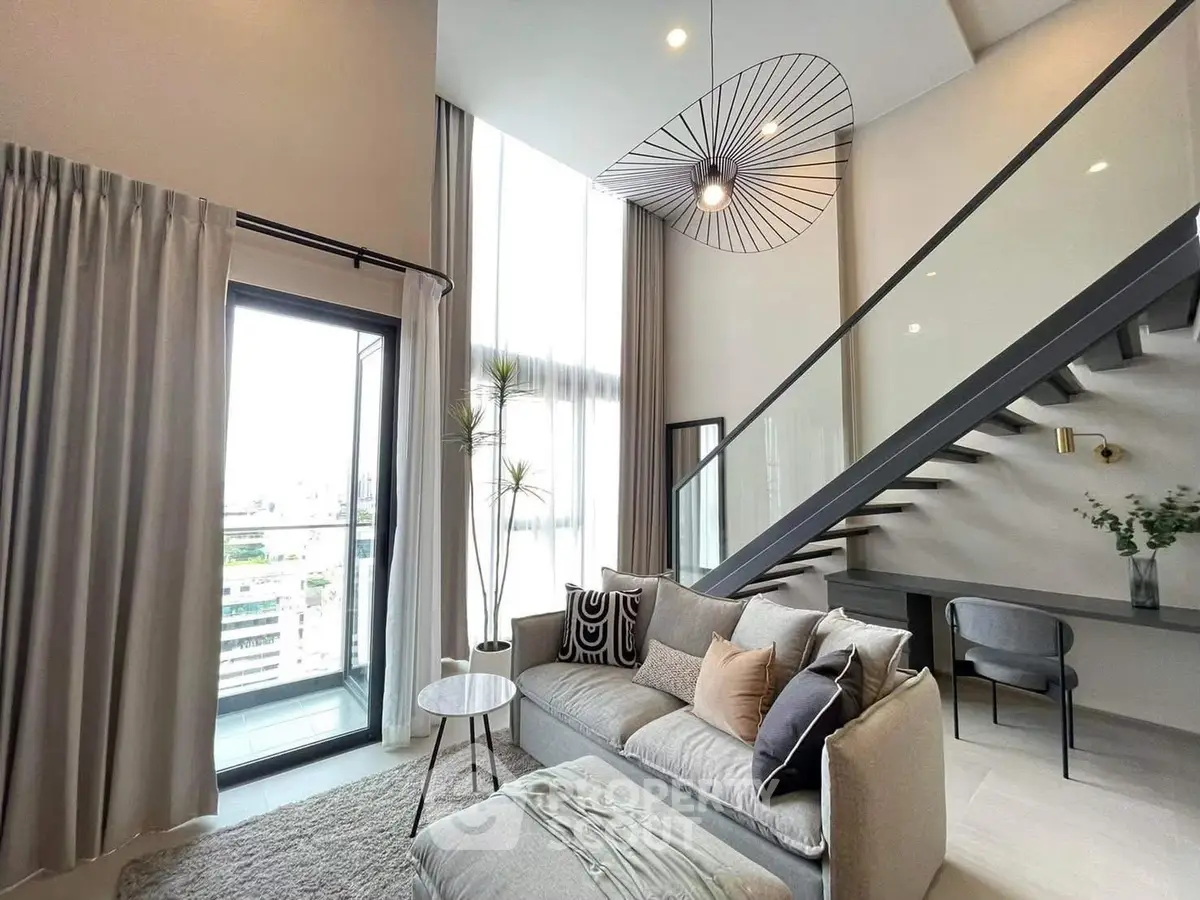 Modern living room with high ceiling and stylish staircase in luxury apartment