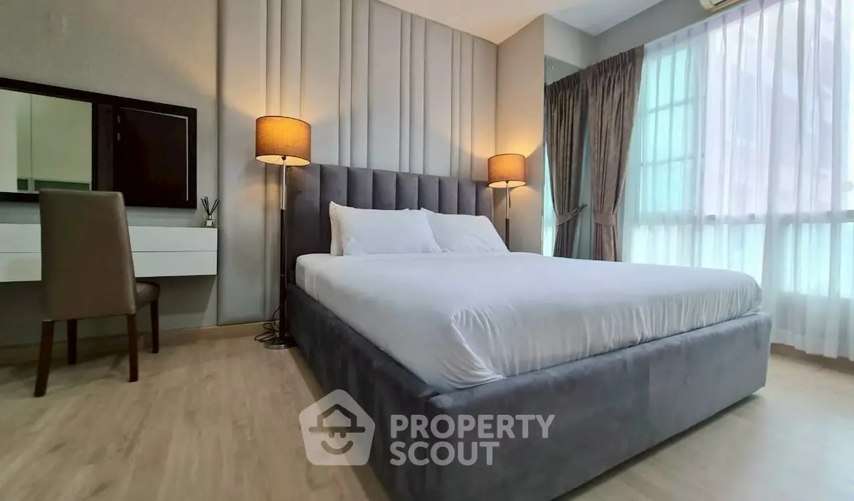 Luxurious bedroom with elegant decor and large windows for natural light.
