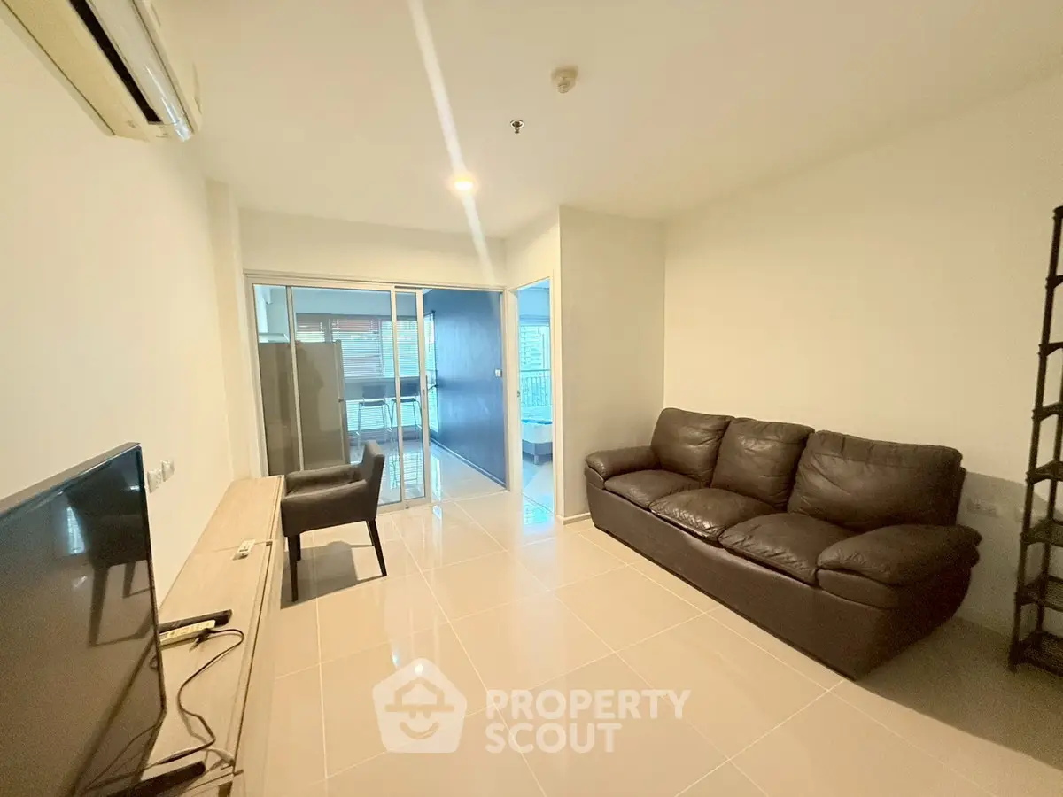 Modern living room with sleek furniture and natural light in a contemporary apartment.