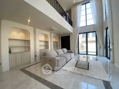 Luxurious modern living room with high ceilings and large windows