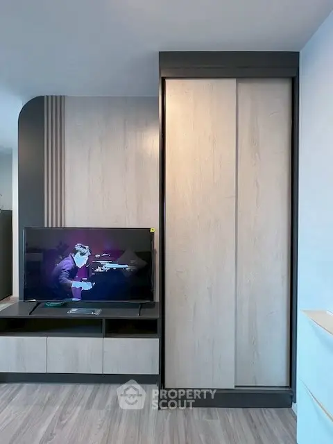 Modern living room with sleek TV unit and stylish wooden paneling