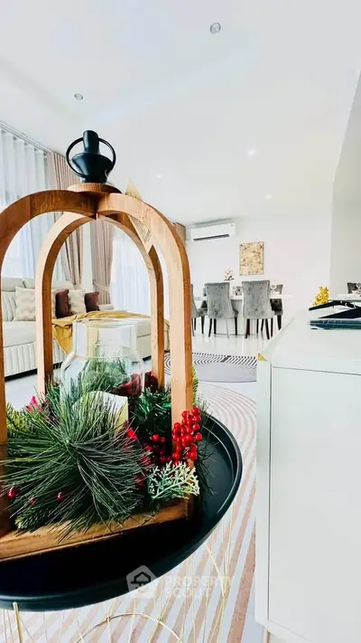 Elegant living room with modern decor and dining area, featuring stylish furniture and bright natural lighting.