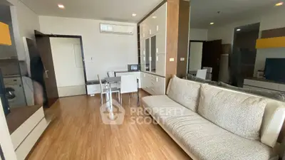 Modern living room with sleek furniture and wooden flooring in a stylish apartment.