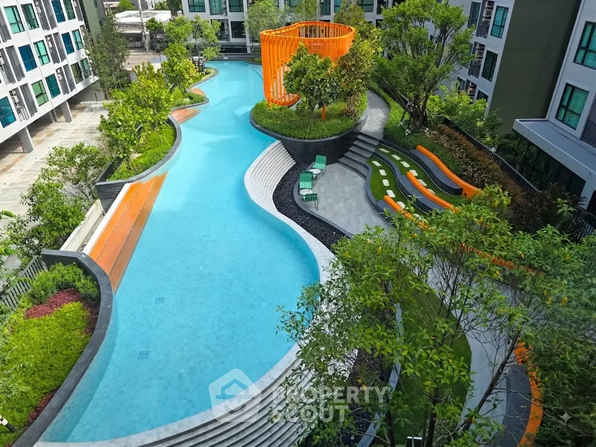 Luxurious apartment complex with stunning outdoor pool and lush greenery, perfect for relaxation and leisure.