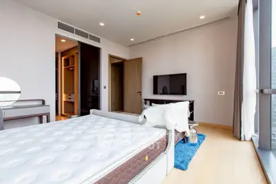 Spacious modern bedroom with large window and stylish decor