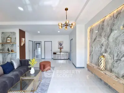 Modern living room with elegant decor and marble accent wall