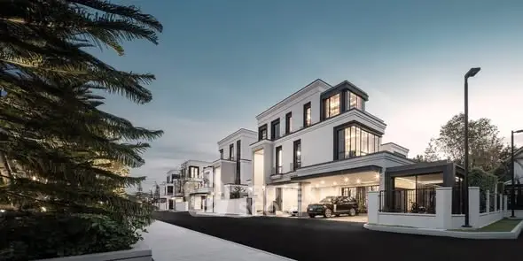 Luxurious modern villas with sleek architecture and spacious driveways at dusk.