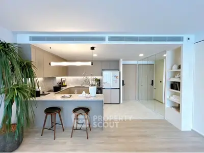 Modern open-plan kitchen with sleek design and stylish bar stools