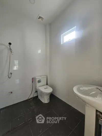 Modern minimalist bathroom with white tiles and sleek fixtures