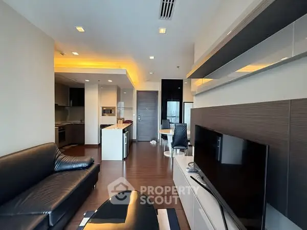 Modern living room with sleek furniture and open kitchen layout