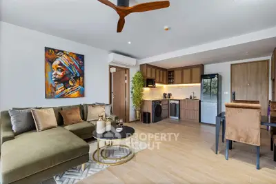 Modern open-plan living room with stylish kitchen and vibrant artwork
