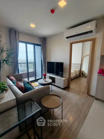 Modern living room with balcony view and stylish decor in a contemporary apartment.