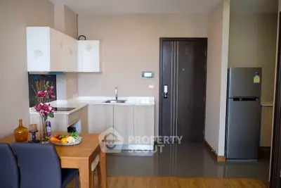 Modern kitchen with sleek cabinets and dining area in a stylish apartment